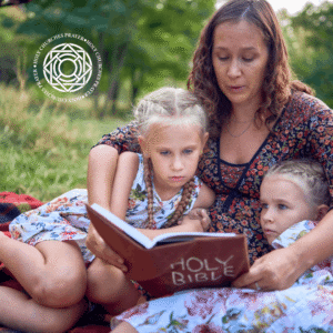 Mother and two daughters reading the Holy Bible on a picnic blanket — how to read the Bible